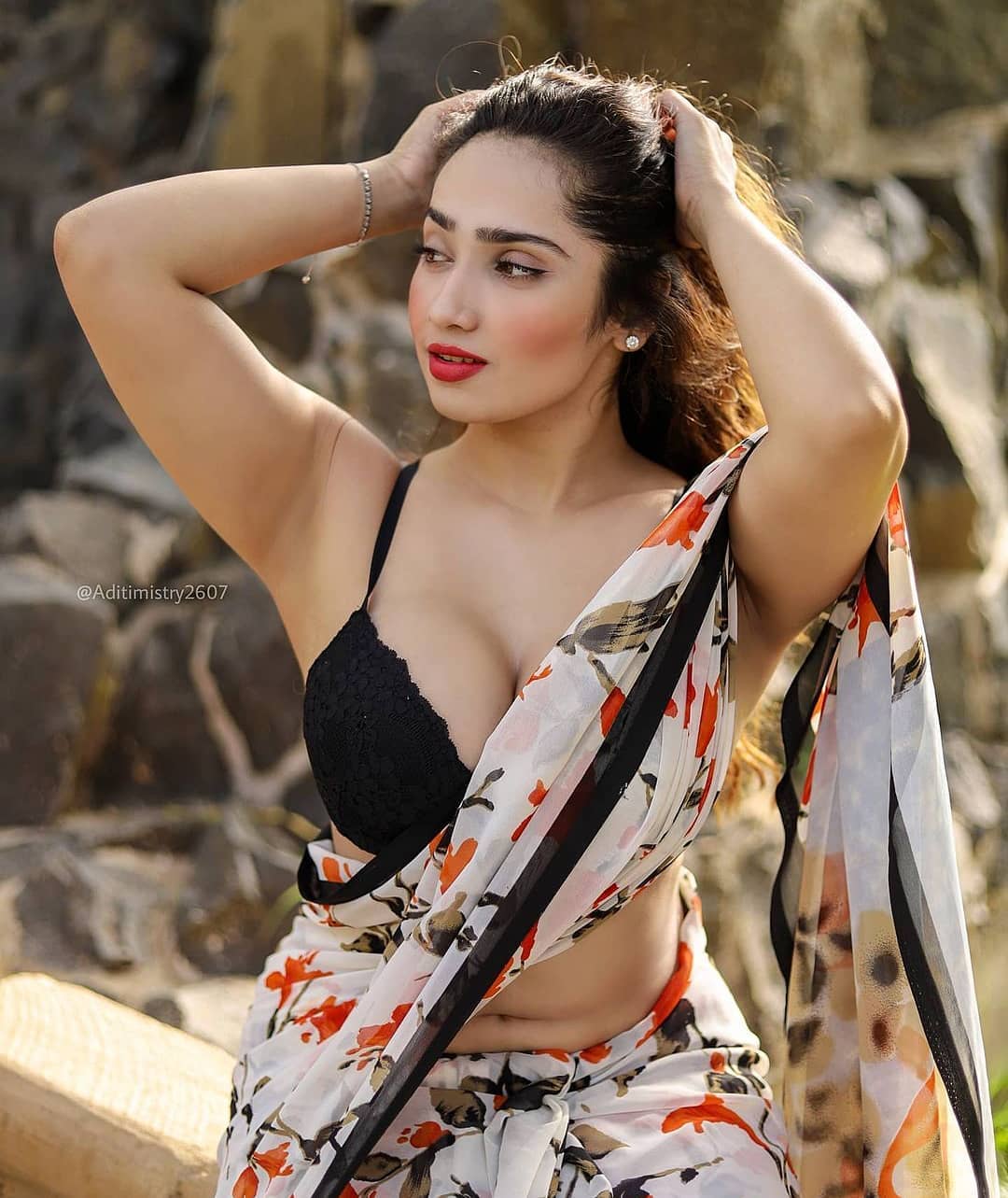 A woman in a yellow dress sits on a chair holding a sign that reads 